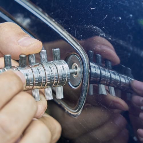 chaveiro abrindo a porta de um carro